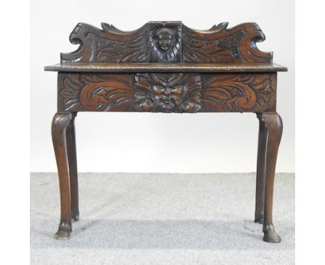 An 18th century carved oak side table, with a gallery back, 93cm 