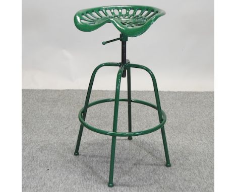 A green painted cast iron tractor seat bar stool