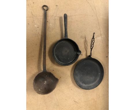 Heavy metal items to include two large skillets and a large forge ladle