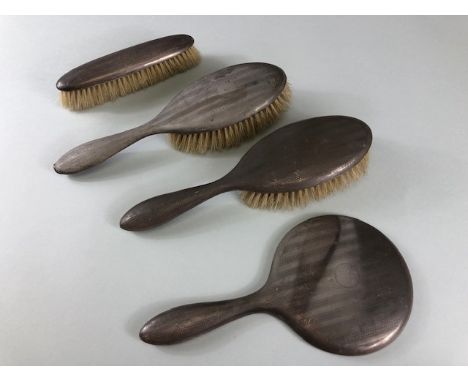 Hallmarked Silver dressing table items to include a circular bevel edged mirror and three brushes (4)