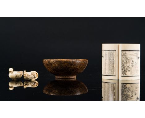 Chinese Art. A stone bowl, an ivory book shaped carving and two netsuke China and Japan, 19th century . The stone bowl engrav