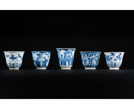 Chinese Art. Five blue and white porcelain cups painted with flowers China, Qing dinasty, 18th century. Three of them bear ma