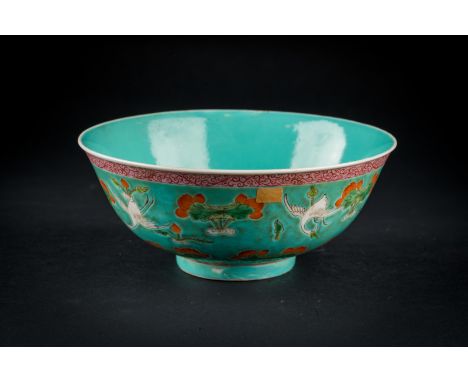 Chinese Art. A porcelain bowl painted with cranes and lotus over turquoise ground and bearing a spurious Qianlong six charact