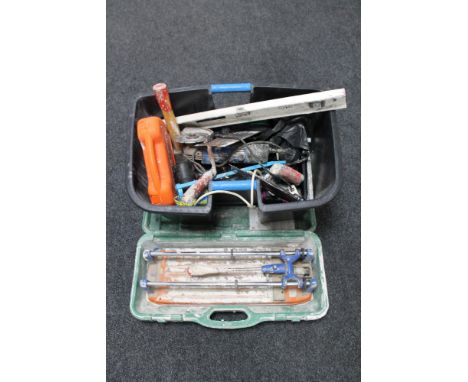 A cased Rubi tile cutter together with a plastic tub of assorted hand and power tools 
