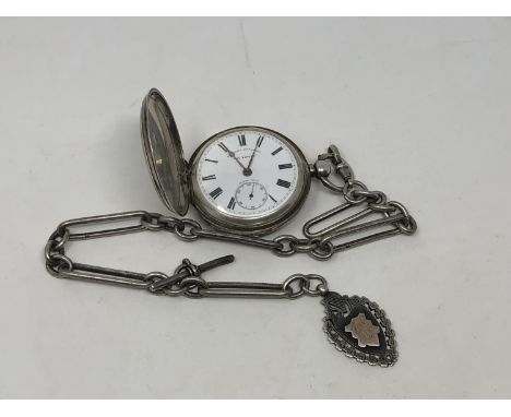 A large heavy antique silver Hunter pocket watch on heavy antique Albert chain