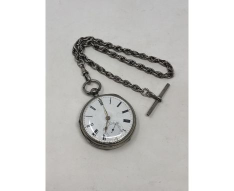 A heavy silver antique pocket watch on silver Albert chain