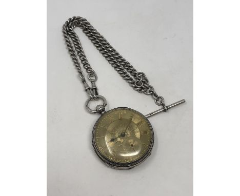 A large antique silver pocket watch on heavy antique silver Albert.