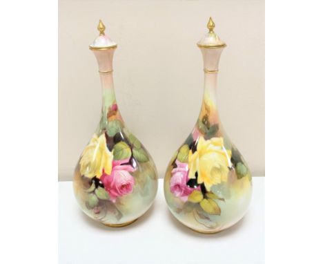 A pair of Royal Worcester hand painted bulbous lidded vases with gilt finials, hand-painted by William Jarman, height 24.5 cm