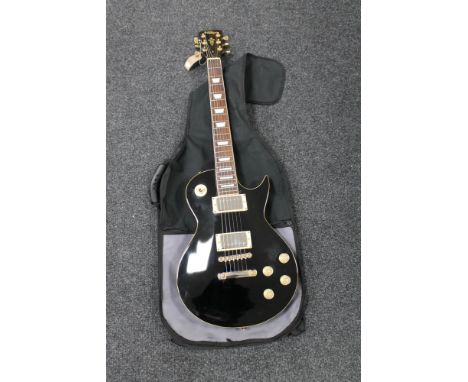A Les Paul style electric guitar by Vintage, in carry bag 