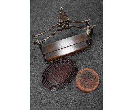 An eastern hardwood wall shelf with pagoda top together with a set of four graduated bamboo and wicker trays and a lidded ric