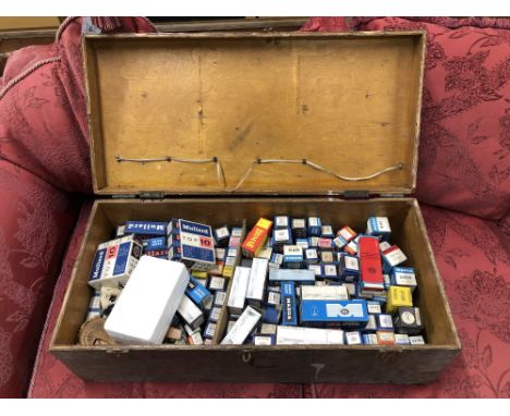 A vintage wooden crate containing a large quantity of vintage radio valves, nut cracker and a 1970's vintage remote control 