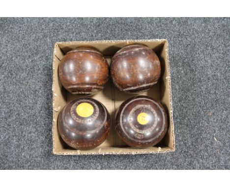 A set of four vintage wooden lawn bowls 