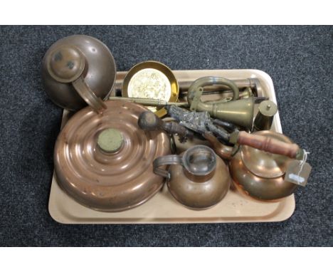 A tray of antique brass and copper ware, kettles, flasks, brass horn and miniature oil lamp, door knocker 