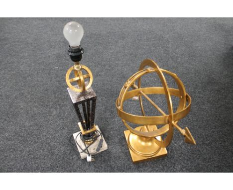 A contemporary metal armillary sphere and a table lamp