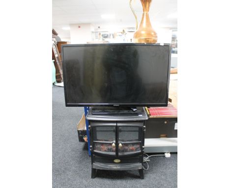 A Hitachi 32" LCD TV with remote together with a Dimplex coal-effect electric fire 