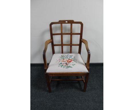 An antique oak tapestry seated armchair