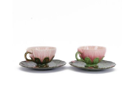 Two Zsolnay Pecs lotus moulded teacups and saucers, with impressed mark beneath