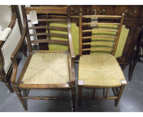 A late Victorian walnut elbow chair with drop in rush seat, together with an Arts and Crafts ladder back side chair, an Art N