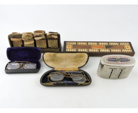 An early 20th century cribbage board, together with a quantity of sundry items including a quantity of bus tickets, spectacle