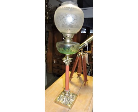 An early 20th Century cast brass and simulated porphery marble oil lamp with clear glass reservoir and etched shade. H. 72cm.