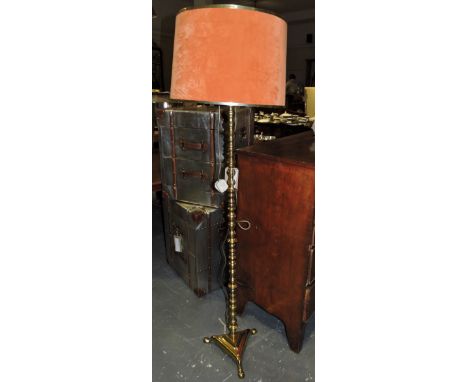 A brass standard lamp with knopped column on triangular platform.