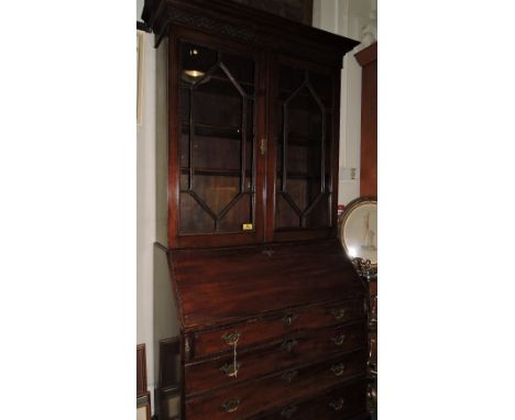A George III design mahogany bureau with later astragal glazed bookcase top over carved fall and four graduated long drawers 