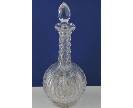 A clear cut glass decanter, with globe shaped body and scaled narrow neck, H. 33cm.