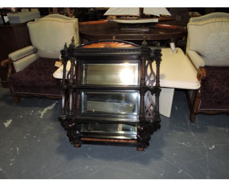 A late Victorian ebonised mirrored three tier wall bracket with paterae pediment over spiral carved fluted square pillars and