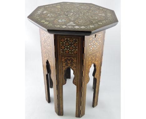 A Middle-Eastern rosewood and mother-of-pearl inlaid work table, the octagonal top inlaid with in a geometric pattern opening