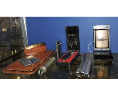 A Metropolitan police whistle, five assorted lighters matchbook holder and cigarette case.