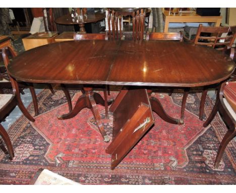 A Regency design mahogany twin pedestal D end extending dining table on fluted tripod bases, 240cm extended, (one spare leaf)