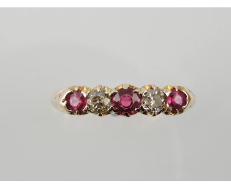 A ruby and diamond set dress ring, in a yellow metal band stamped 18ct, 3g.