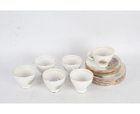 Collection of six each Royal Vale tea cups, saucers and side plates, depicting a cottage scene (qty)