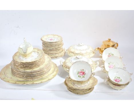 Habitat gilt teapot, together with a collection of porcelain dinnerware, centred with a rose within gilded borders on a yello