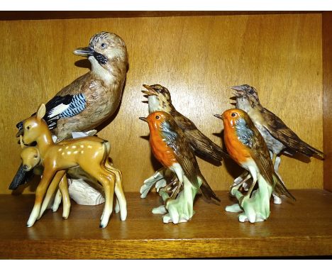 A collection of five Goebel bird ornaments, including a jay, 23.5cm high, two song thrushes 16cm, (one with repaired beak), t