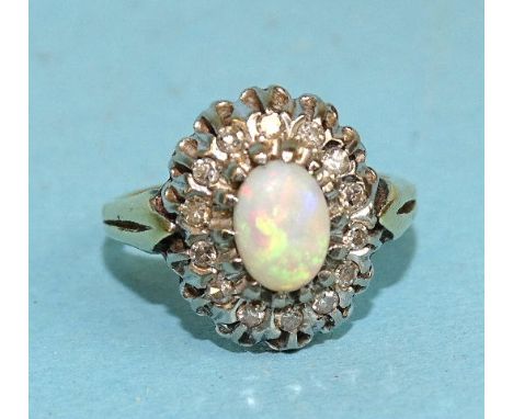 An opal and diamond cluster ring, claw-set an oval opal within a surround of fourteen 8/8-cut diamonds, in 18ct yellow and wh