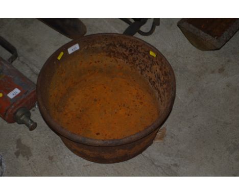 A circular cast iron trough