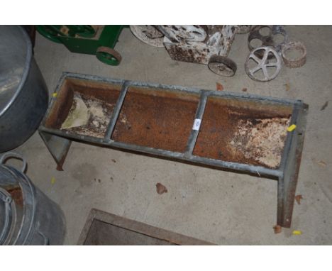 A galvanised three section pig trough 