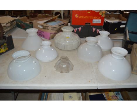 A collection of various Victorian and Edwardian opaque glass lamp shades and a clear moulded glass shade 