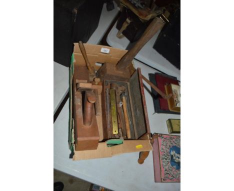 A small collection of woodworking tools including a plane, various gauges, a spirit level, mallets etc.