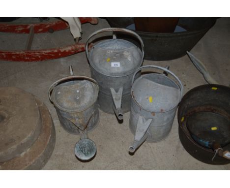 Three vintage galvanised watering cans
