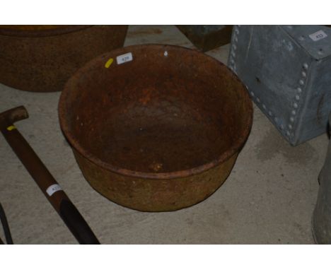 A vintage circular cast iron trough