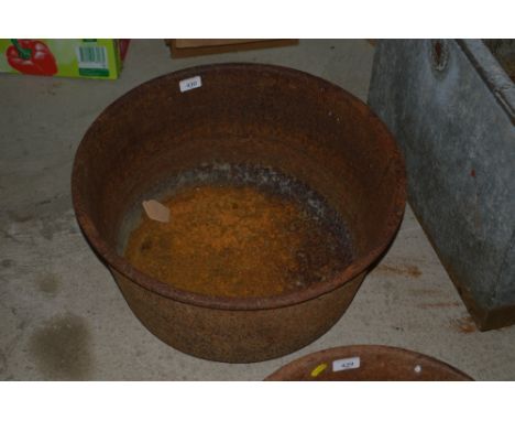 A vintage circular cast iron trough