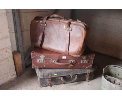 A vintage leather holdall and two suitcases