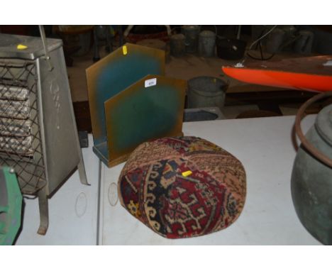 A vintage upholstered kneeler and an Art Deco style magazine rack