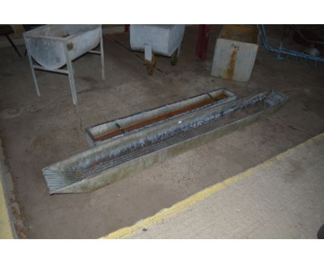 A long galvanised foot bath and a galvanised feed trough