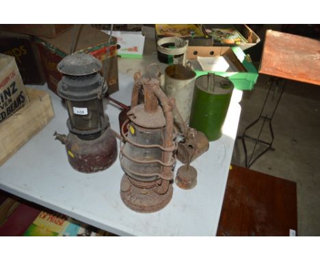 An old Tilley lamp, a Hurricane lamp, various oil cans etc.