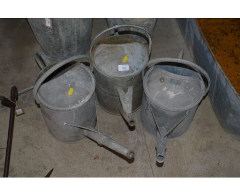Three vintage galvanised watering cans