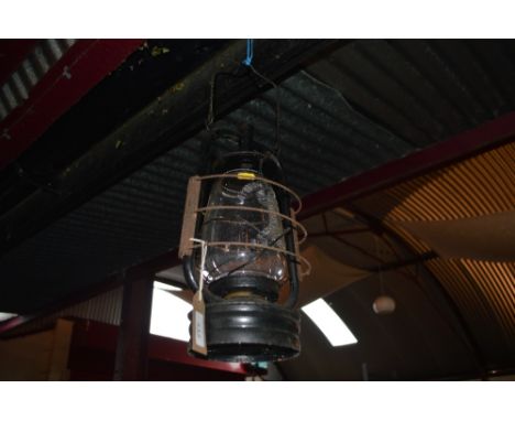 A vintage Hurricane lamp, the moulded glass shade impressed "It won't go out" and a Chelwin Hurricane lamp