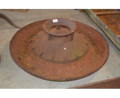 An old cast iron circular pig trough 